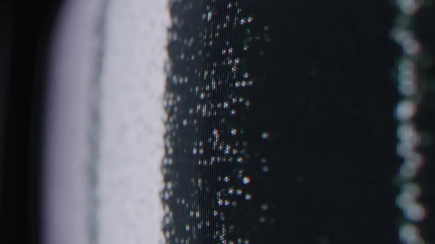A television displays white noise for a while before switching back to the rainbow display