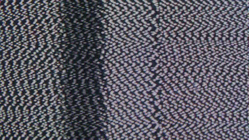 A video shows a closeup shot of a television screen with a lot of static the screen is filled with a black white and gray pattern of grainy noise