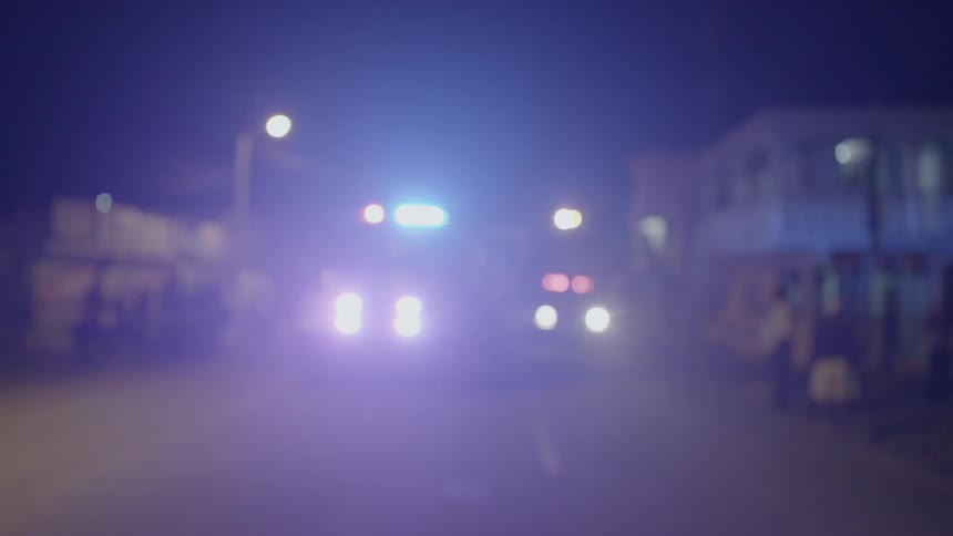 An emergency vehicle is stopped with its lights flashing