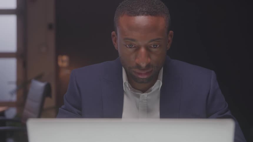 Concentrated man typing on a laptop