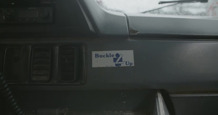 Buckle up sticker on dash of vehicle