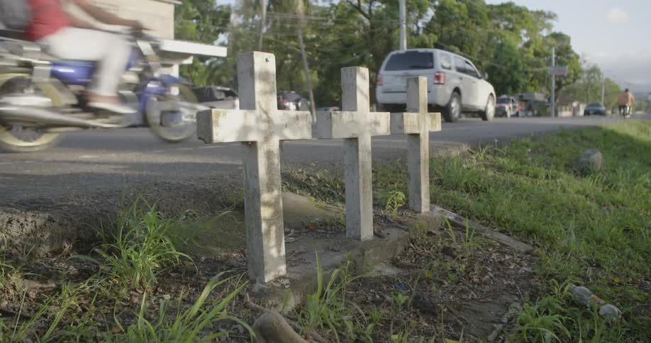 Three crosses next to a busy road