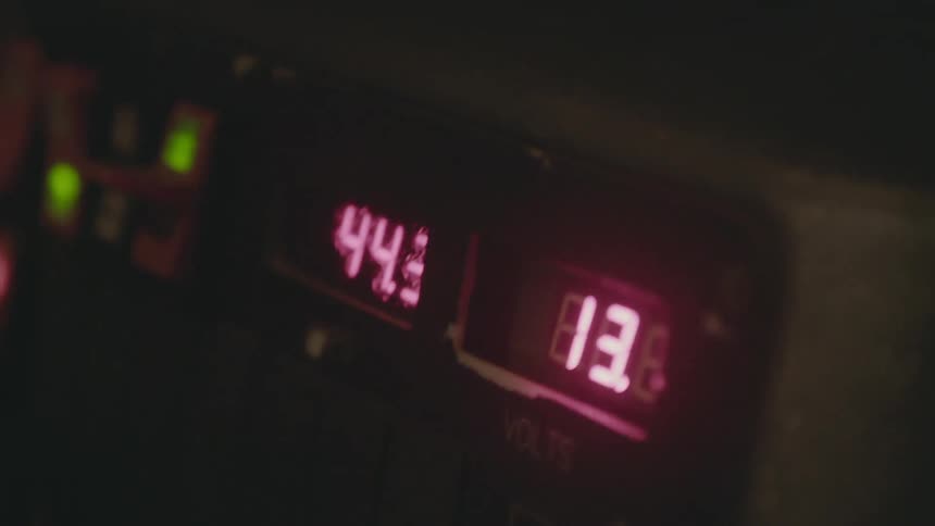 A vehicle dashboard displays number