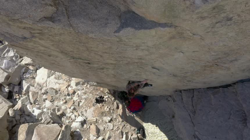 Person climbing a mountain wall