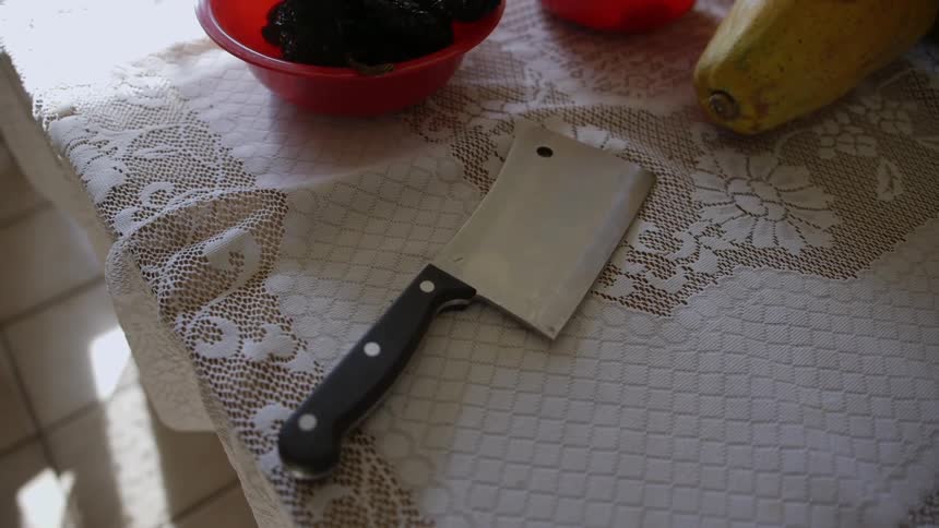 Large knife sitting on kitchen table
