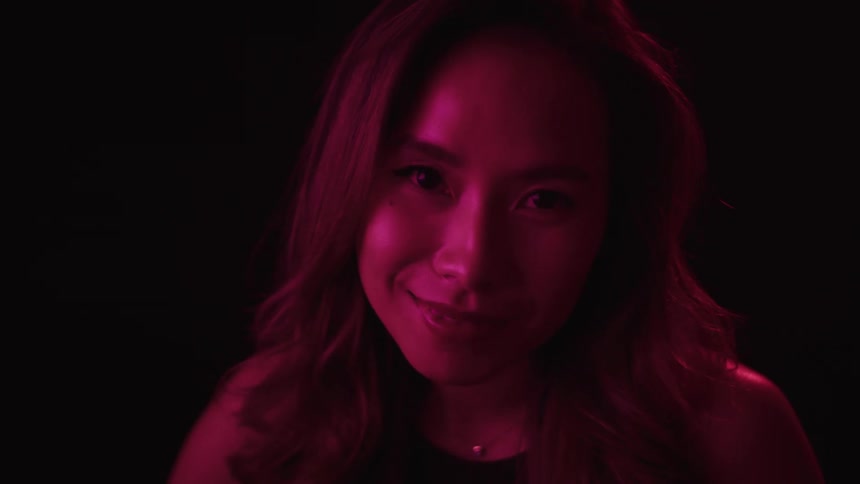 The woman smiles and blinks