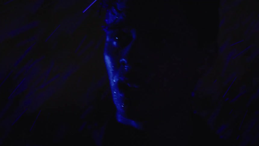 A man stands in the pouring rain