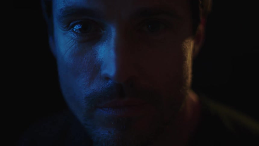 The man is standing in the dark