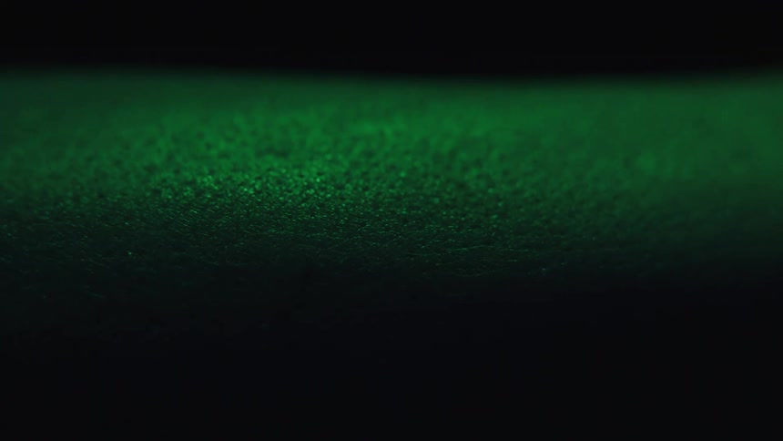 A arm with goosebumps is shown in closeup under low light
