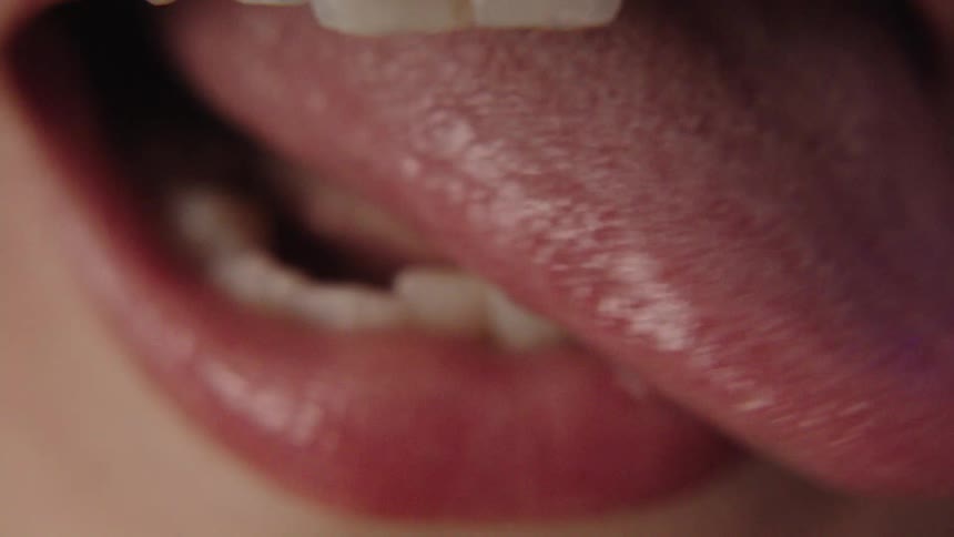 A human tongue wagging side to side of the mouth