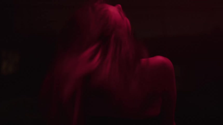 A lady dancing in a dark room