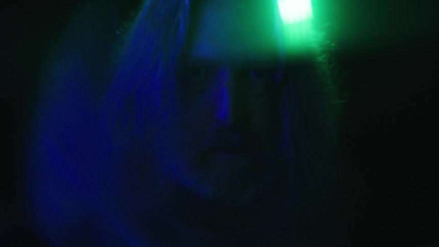 The man has a green light behind him