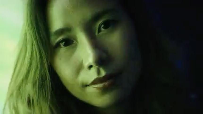 Woman looks in closeup with a serene expression