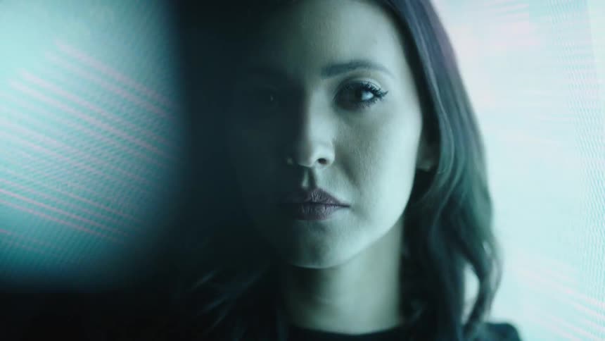 Lights stream past the womans face