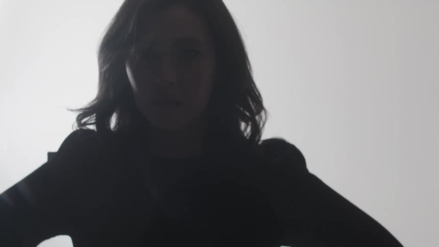 Female silhouette contrasted against a bright white background