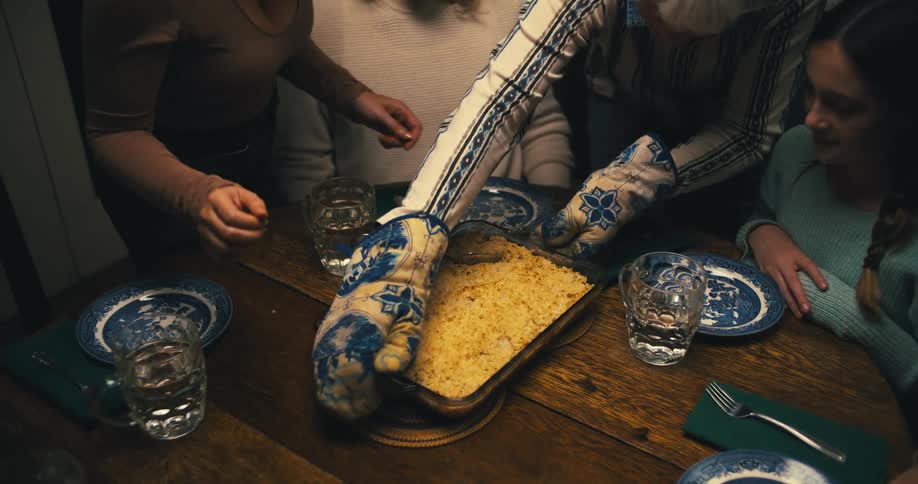 Family gathers at a warmly lit table for dinner