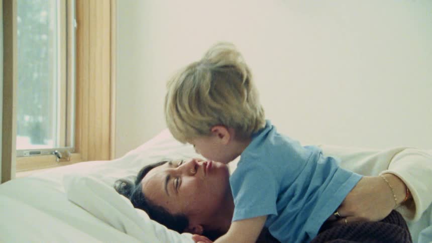 Woman smiles while sharing kisses with her grandson