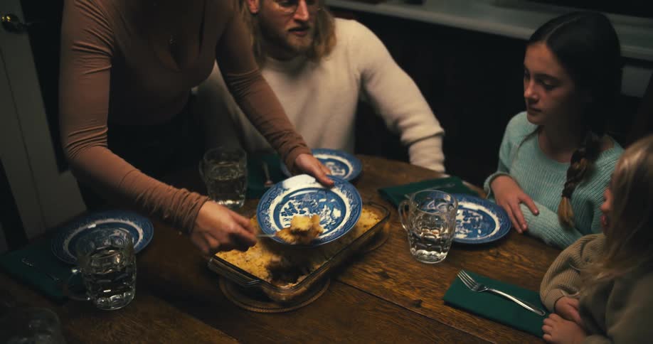 A family shares dinner together at the table