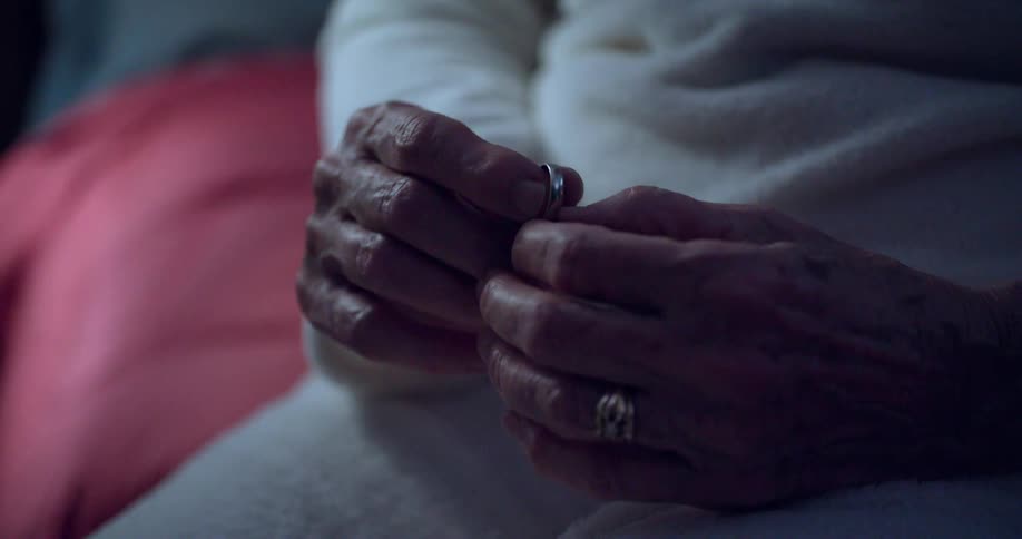 A womans hands holding a ring