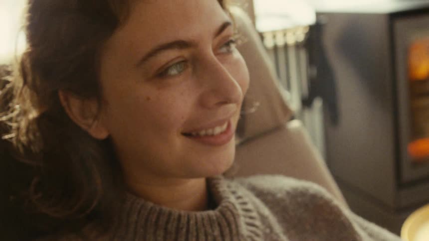 Woman smiling softly while looking to the side