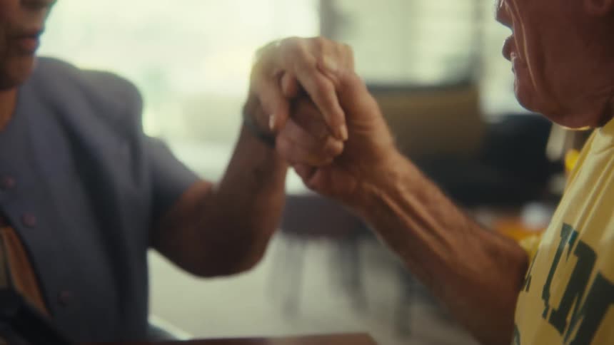 A couple hold hands while looking at a calculator
