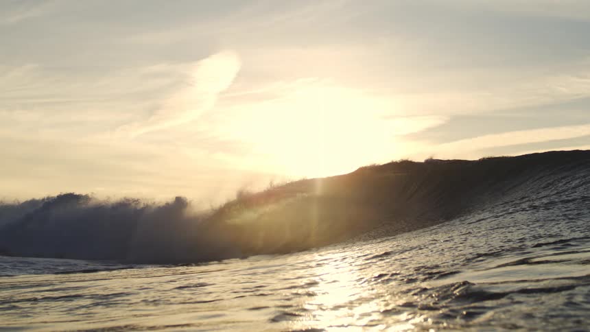 Wave breaking in the ocean during sunset