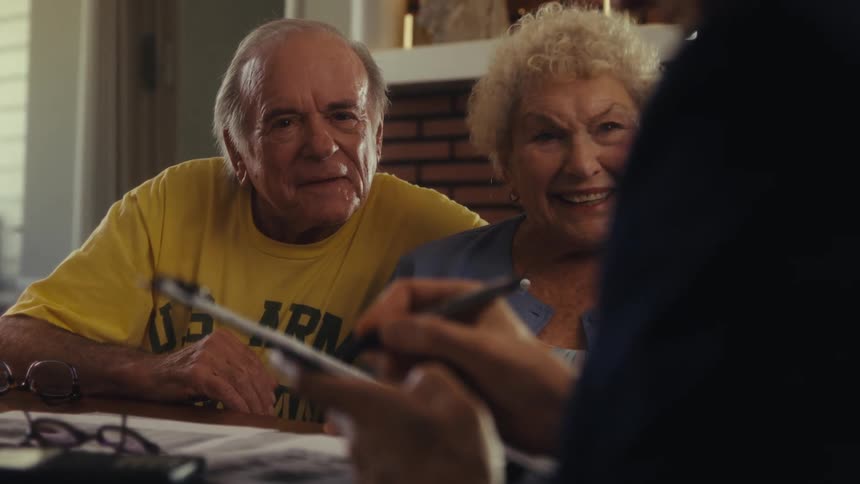 Man talking with a couple and filling out a form