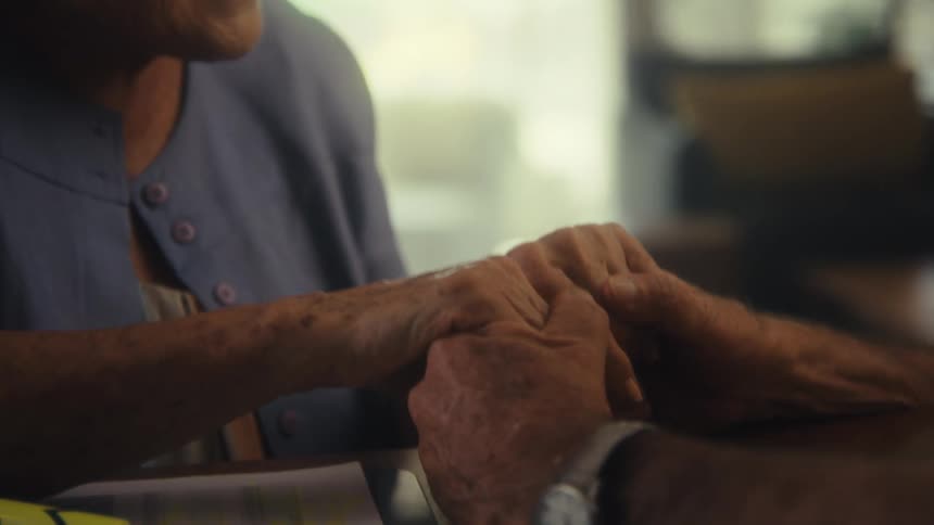 Elderly couples hands intertwine in a gesture of affection