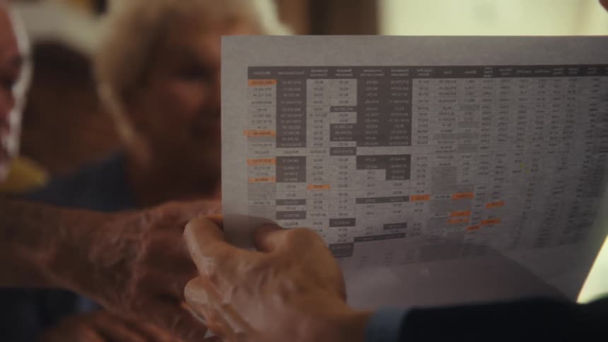 People are having a conversation while examining a document