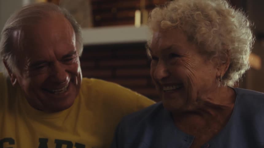 Elderly couple smiling together in a joyful moment