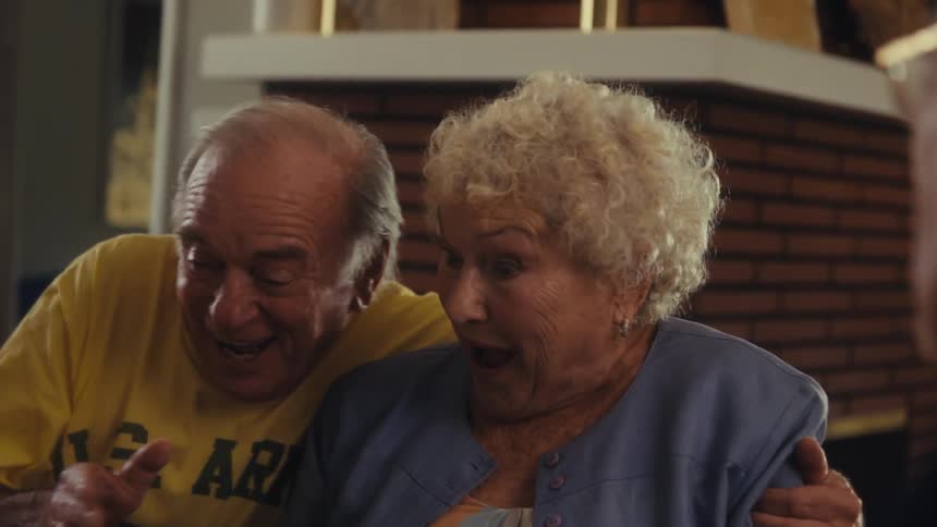 Man talking to a cheerful elderly couple
