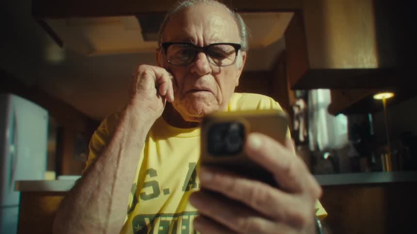 The man presses the screen on his phone