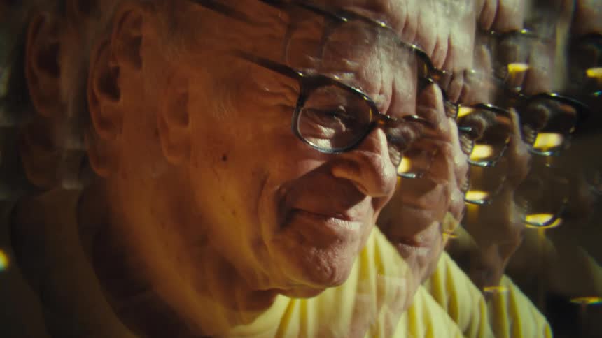 Smiling elderly face duplicated by reflection effect