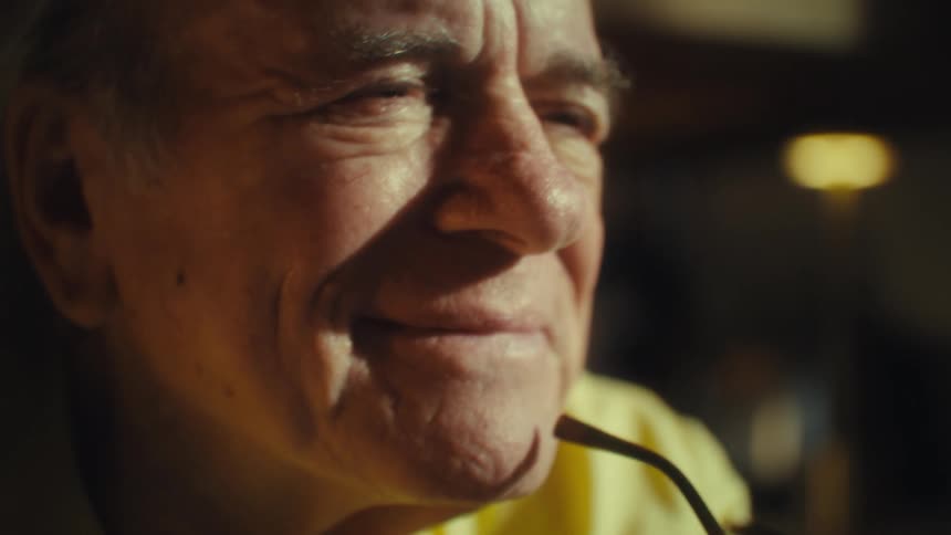 Closeup of an elderly man smiling with a serene expression