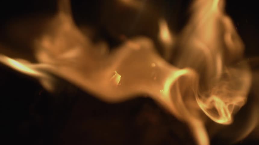 A campfire is burning at night