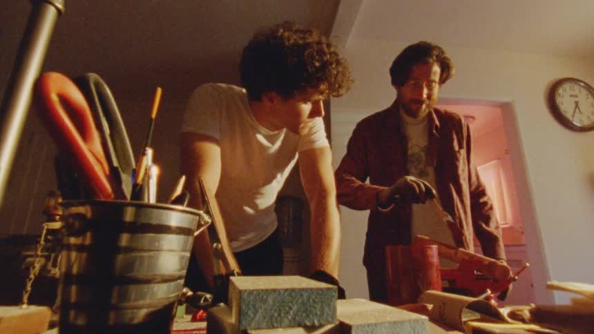 Two men work together in a workshop