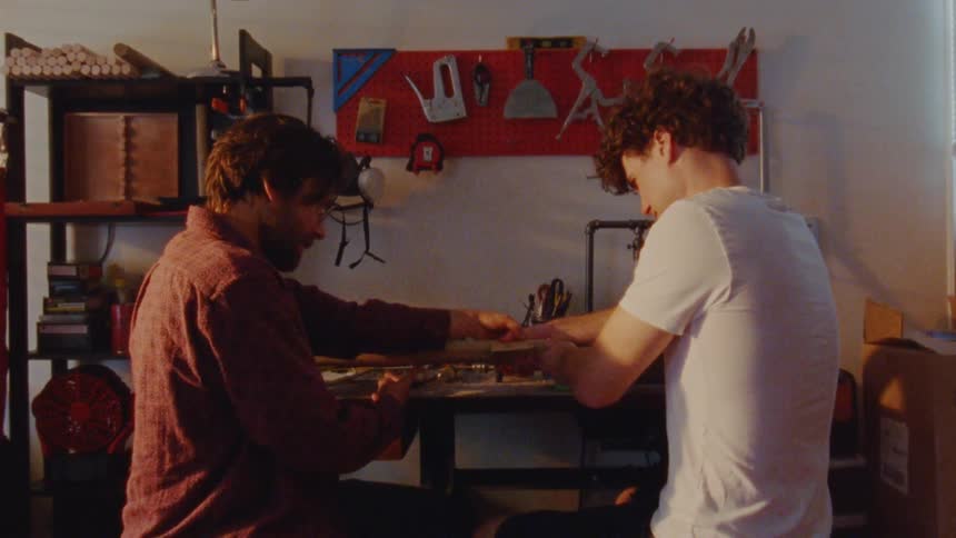 Two men are working together in a workshop