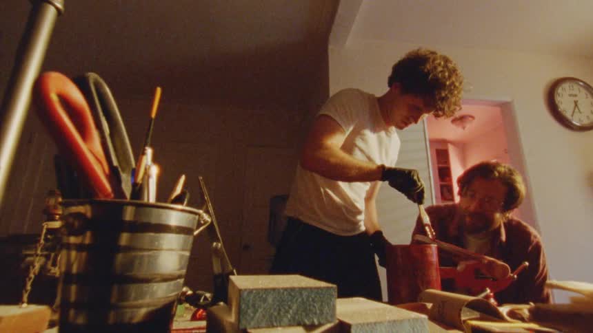Two men work together in a carpenter workshop