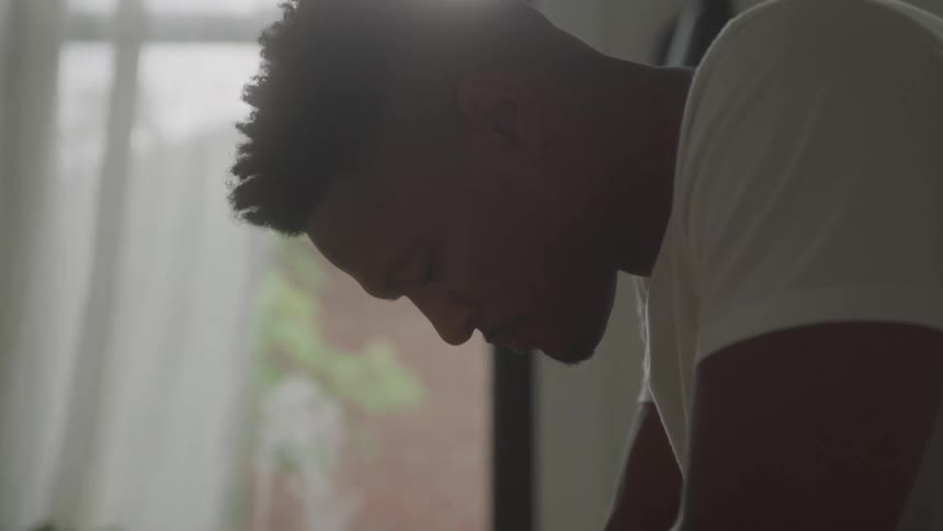 Man tilts his head downward in a thoughtful expression