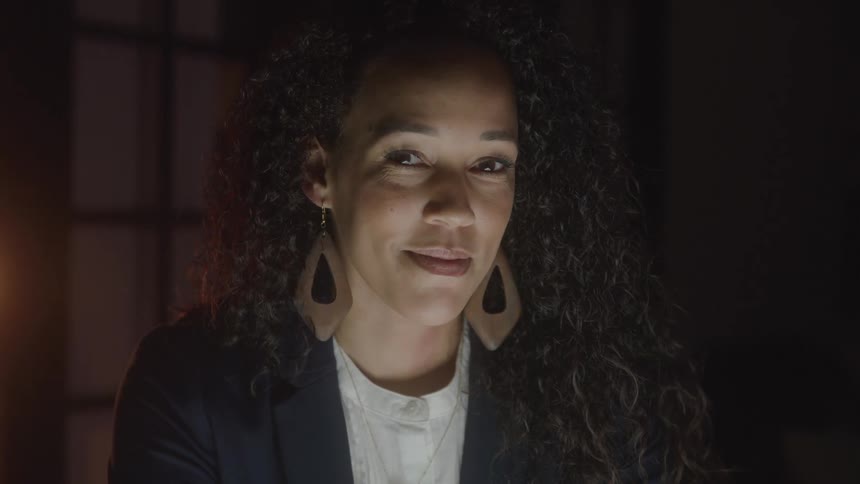 A woman looking into the camera with a calm expression