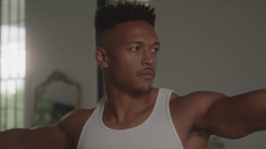 Man in a room of the house with his arms open