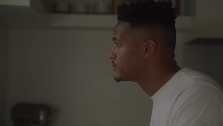 Man stares intently forward in a welllit indoor setting