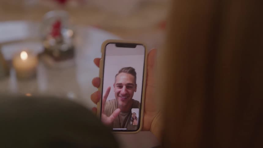 A man on a video call waves