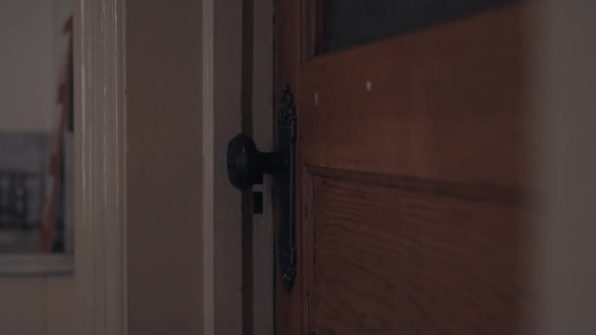 The door slowly opens