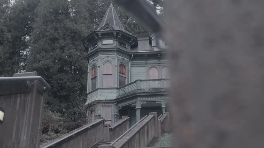 Rain pours down around the large home