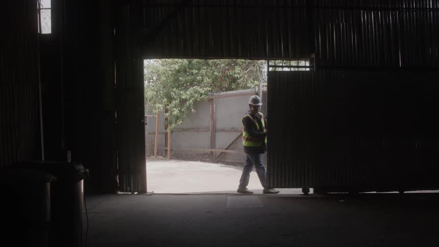 Man at work opening a gate