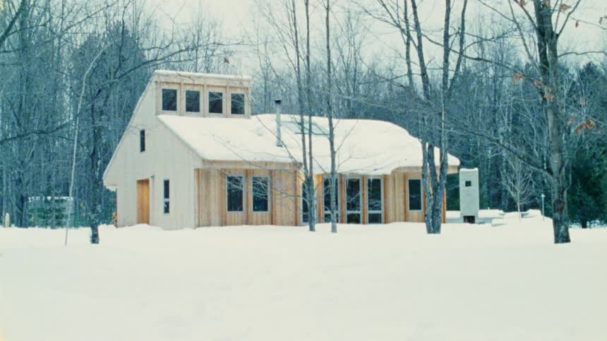 Remote cabin in the woods surrounded by snow in the winter