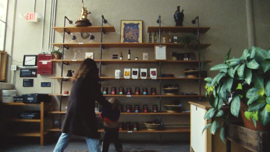 Mother and son walk into a coffee shop