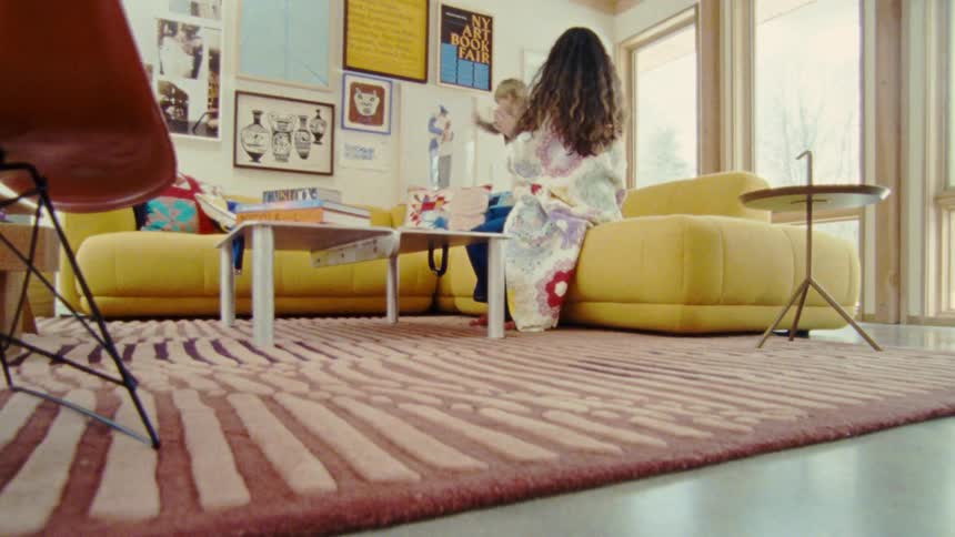 A mother and child play together in a cozy modern living room