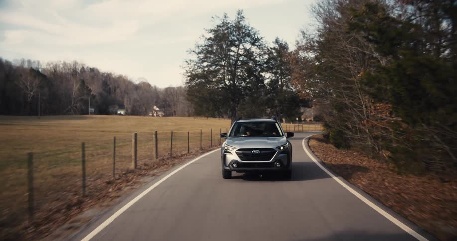The car passes by the fields